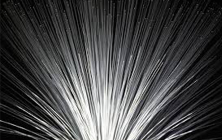 A close-up view of numerous thin, light-emitting fiber optic strands fanned out in all directions.