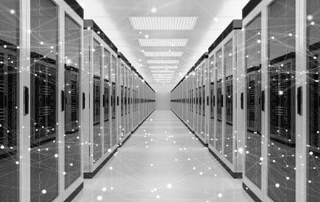 Black and white image of a server room, with two rows of neatly organised servers.