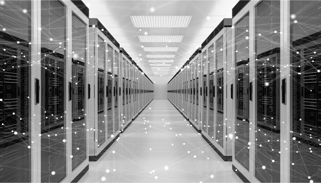 Black and white image of a server room, with two rows of neatly organised servers.